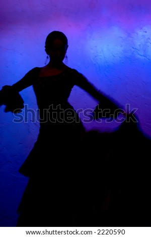 Flamenco dancer silhouette over blue background