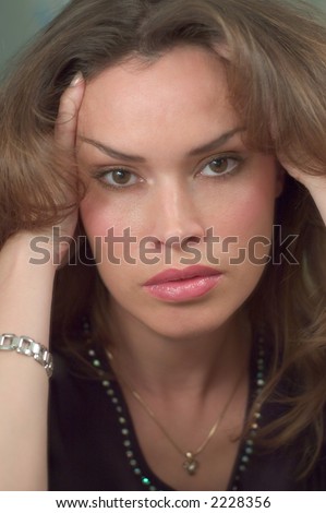Beautiful woman head portrait with her hands to her hair