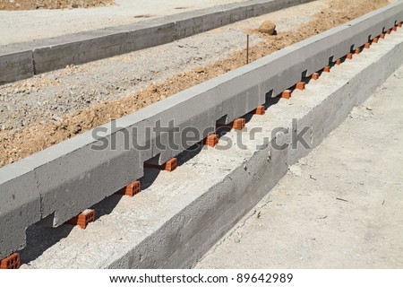 Concrete curb at road construction site. The road is ready to be asphalted.Shallow DOF