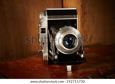 Old vintage film camera on wooden background
