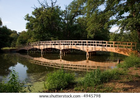 Old wooden bridge over water in the castle park