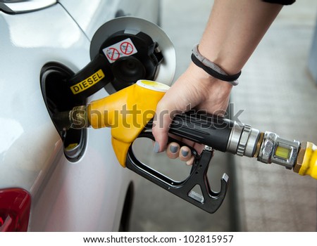 Driver pumping gasoline at the gas station