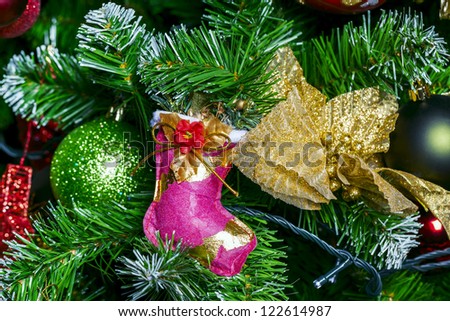 Christmas sock on Christmas tree with decorations for New Year