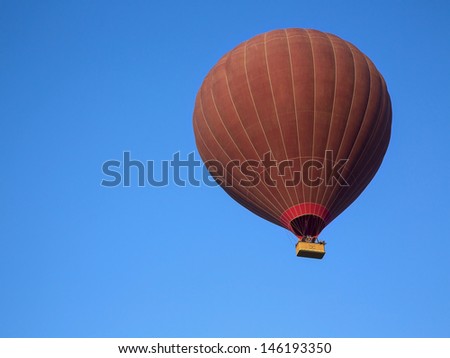 Silhouette of balloon on blue sky background, landing at Sunrise