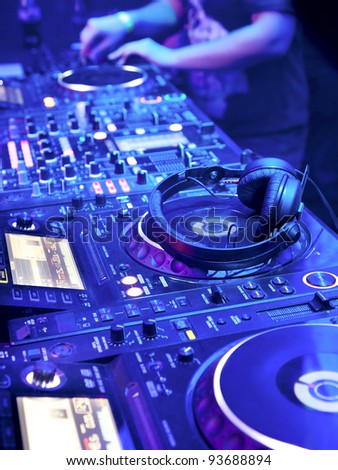 Dj playing the track in the nightclub at a party. DJ headphones