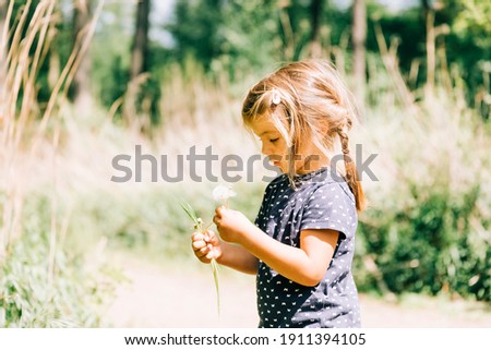 Similar – Image, Stock Photo Child holding dandelion