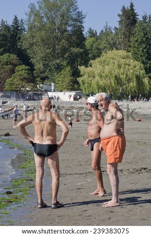 VANCOUVER, CANADA - AUGUST 5, 2005: Three senior men standing on Second Beach in Stanley Park. Stanley Park is an urban park of more than 400 hectare and was opened in 1888.