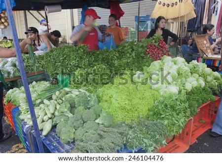 SAN JOSE, COSTA RICA - AUGUST 31, 2008: Market Vendors selling vegetables on farmers market in San Jose, Costa Rica. This is a traditional way of selling agricultural products.