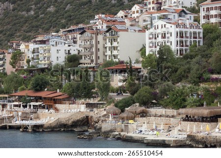 KAS, TURKEY - OCTOBER 15, 2009: Modern Apartment buildings and beach with Cliffs in the village Kas in Turkey. Kas is a small fishing, diving, yachting and tourist town and part of Antalya Province.