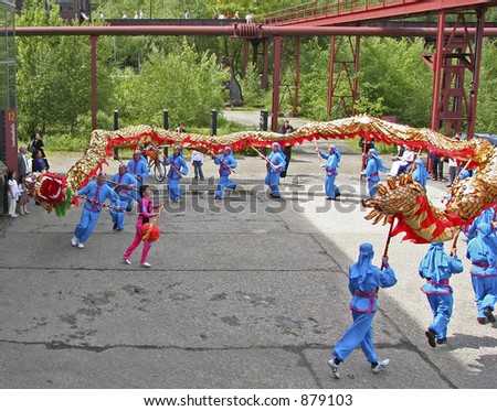 dragon-dance - performers running in a circle - backdrop: an old coal mine