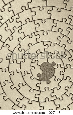jigsaw in sepia with one missing piece - pieces fitting together in form of a spiral