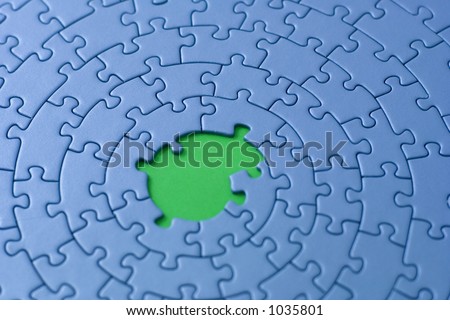 blue jigsaw with missing pieces in the center - shallow DOF, focus is on and over the missing pieces