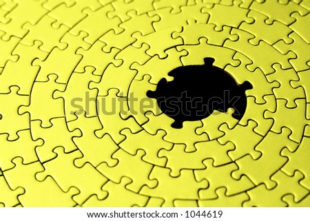 abstract of a yellow jigsaw with missing pieces in the black center - shallow DOF, focus is on the big hole