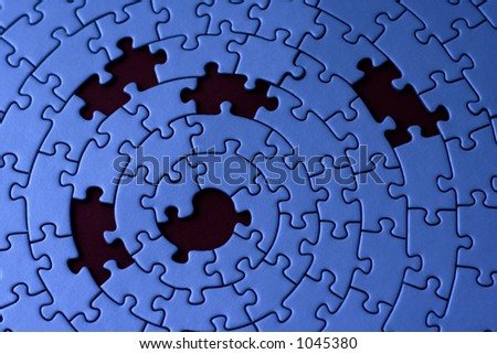 jigsaw in blue with five missing pieces - focus is on the center