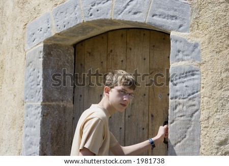 teen opens an old door - door to history or door to the past - french riviera