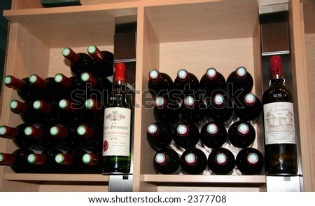 wine bottles in a rack - saint-emilion, france