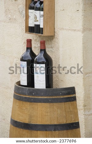 3l wine bottles on a wine cask - saint-emilion, france
