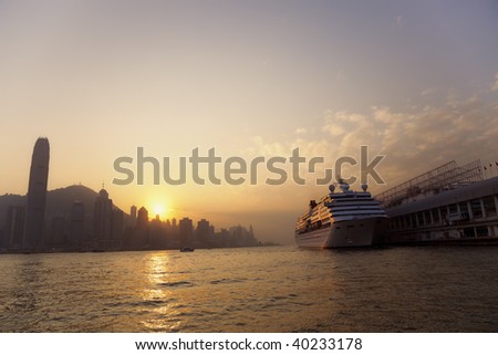 Cruise Ship with Skyline of Hong Kong at Sunset
