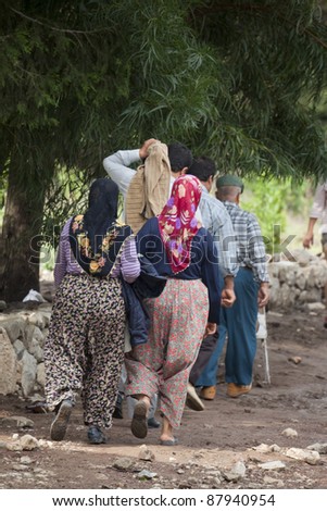 OLYMPOS, TURKEY - OCTOBER 14: Worried turkish people in a hurry after flood disaster on October 14, 2009 in Olympos, Turkey. The floods destroy roads and houses and swept away about 50 cars.