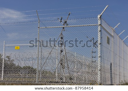 Razor wire and fence in sun - Nuclear fuel reprocessing plant in La Hague, Basse Normandy, France, Europe