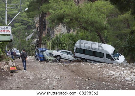 OLYMPOS, TURKEY - OCTOBER 14: Crashed cars and people in the woods after flood disaster on October 14, 2009 in Olympos, Turkey, Asia. The floods destroy  roads and houses and swept away about 50 cars.