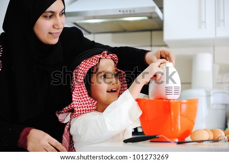 Muslim mother and little son in the kitchen