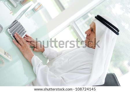 Portrait of a smart arabic business man using laptop