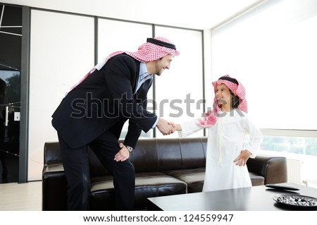 Arabic Muslim business people with children at office
