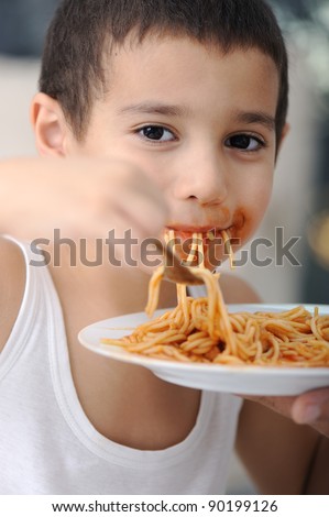 Tasty food, messy child eating spaghetti