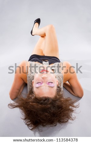 Sexy young woman with crazy hairstyle posing in seductive pose.
