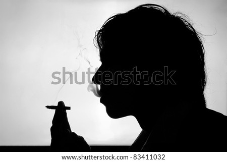 Black and white silhouette of smoking young man