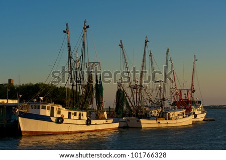 Shrimp boats at anchor in small river port in South Carolina in evening light