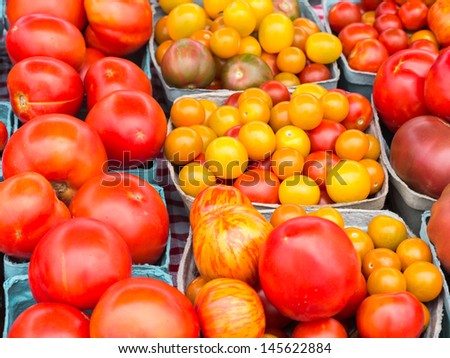 A group of red and yellow tomatoes of varying size at Delaware farm market.