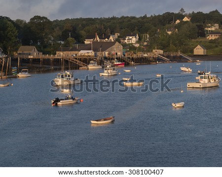 Coastal harbor in Maine as dawn breaks filled with lobster and fishing boats.