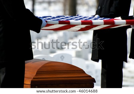 US Flag being held over casket at Arlington National Cemetery