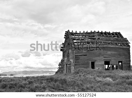Black and white photo of old abandoned wooden farm house in advanced state of decay in the Palouse region of Washington state in the US