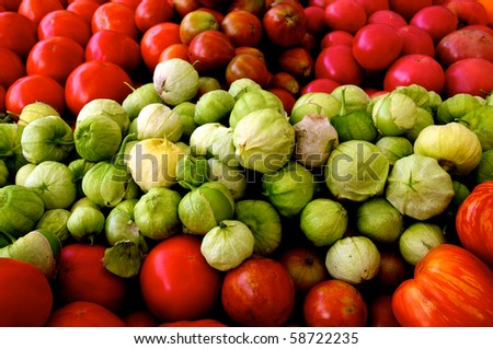 Horizontal photo of pile of tomatoes and tomatillos at farm market