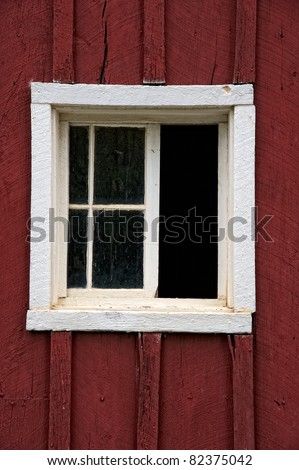 Architectural detail of old wooden window on side of old wooden farm structure