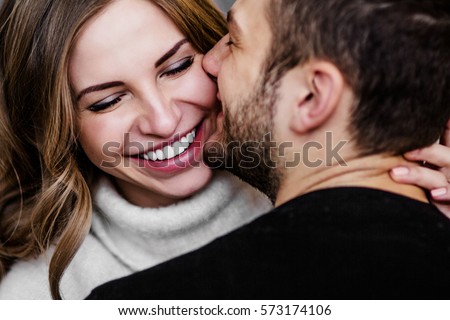 Photo of Young couple in love hug each other on the black background 