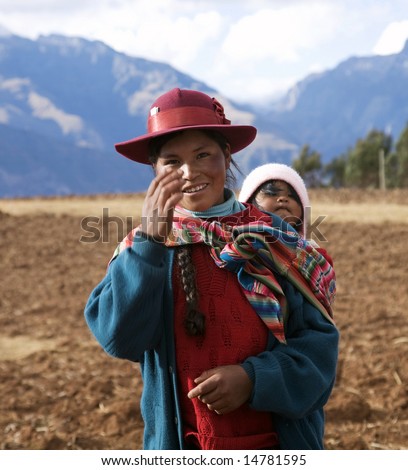 PERU - AUGUST 1: A native Peruvian woman gestures while carrying a baby August 1, 2007 in Sacred Valley, Peru.