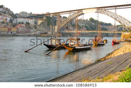 Panorama old Porto river Duoro, vintage port transporting boats, old town, town of Gaia and famous bridge Ponte dom Luis Portugal