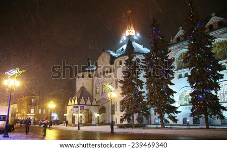 Nizhny Novgorod, Russia - December 22, 2014: Christmas snowfall in the evening on the main street Bolshaya Porkrovskaya. Central Bank of Russia located here. This is a very old building museum.