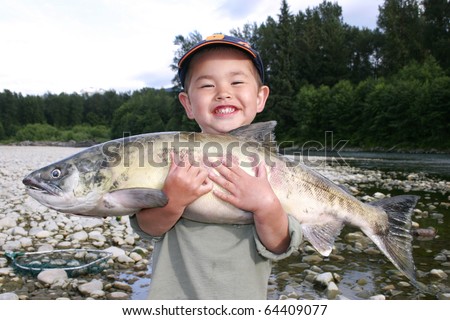 Similar – Image, Stock Photo child holding a fish and showing it to the camera