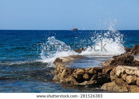 Waves break againstthe rocks. Island Hvar, Croatia, Adriatic Sea. waves break / batter against the rocks