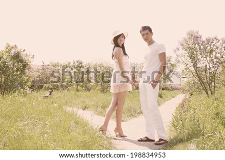 Young couple walking in the park holding hands