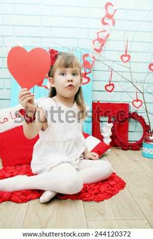 Little girl in the festive decor for Valentine\'s Day