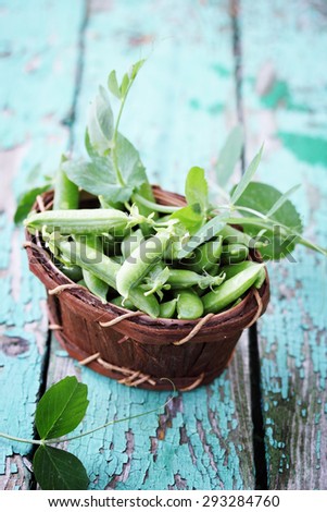 Green peas in a basket made of birch bark