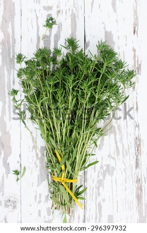 Fresh bundle of savory on the wooden table