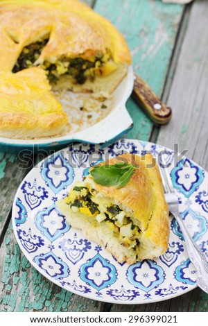 Homemade pie with onion, spinach and eggs