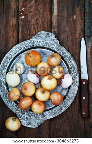 small onion in an old metal tray